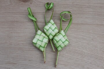 Ketupat or rice cake on a wooden table. Traditional Indonesian food during Eid al-Fitr