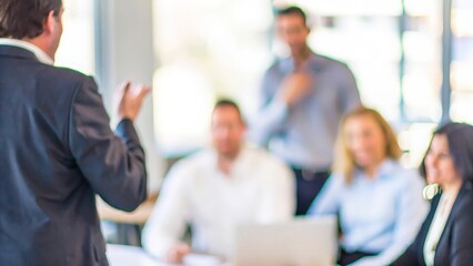 Empowered Business Team: A business leader empowering the team with a blurred office environment in the background to show leadership and teamwork.
