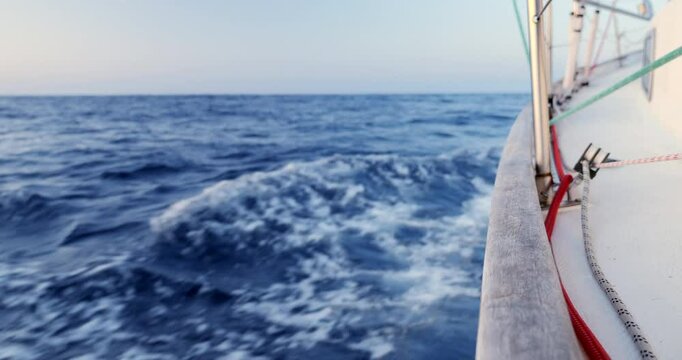 Port side a sailboat cutting trough the ocean while crossing the Bay of Biscay Stock Footage