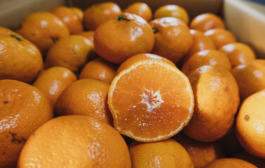 mandarin in section against the background of a large number of mandarins