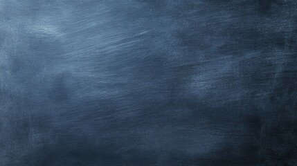 Obraz premium A textured dark blue background resembling a chalkboard or canvas.