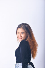 Obraz premium A young Asian Woman in a Black Velvet Top and Denim Jeans making expressive gestures Isolated on white background