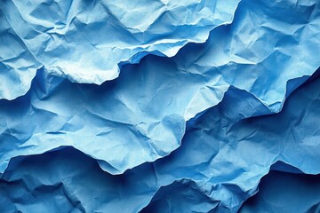 Fototapeta premium Crumpled blue paper texture showcasing intricate patterns and shades of color in natural light