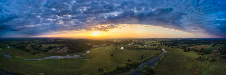 Breathtaking morning landscape near the river in the meadow, stunning panorama
