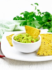 Guacamole in bowl on light board