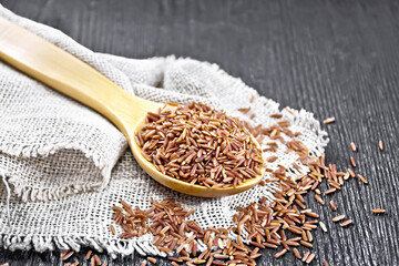 Rice red in spoon on board