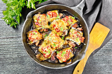 Rolls of eggplant with meat in pan on board top