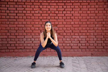 Young Woman Practicing Squat Exercise