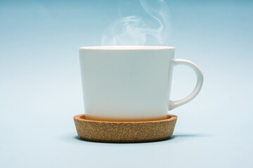 White porcelain tea or coffee cup on blue background