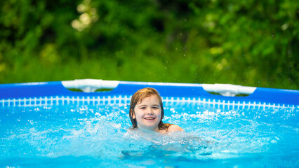 Happy little kid swimming in home pool on hot summer day. Boy swim in inflatable circle pool on summer day on home yard. Kids swimming pool at home. kid playing in inflatable pool on backyard.