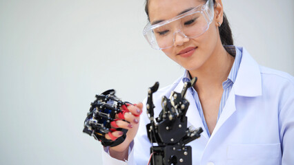 Female Scientist Working with Robotic Hand in Laboratory. Innovation in Robotics, Engineering and Technology Development. Modern Research and Experimentation for Education.