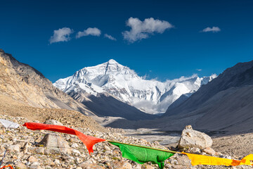 Prayer Flags blowing in the wind with Sun Flare blue sky in Tibet China
