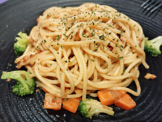 vegetarian pasta dish served in a black plate