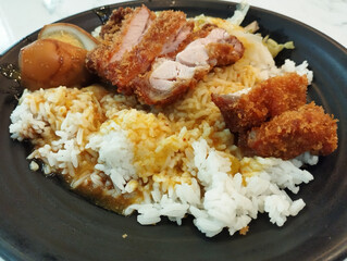 pork cutlet curry rice in a black plate