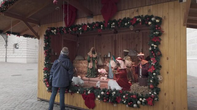 Woman visits large nativity scene set up in public square, Budapest