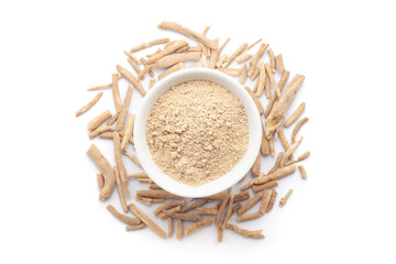 A bowl of Organic Ashwagandha (Withania somnifera) powder, placed over a heap of whole ashwagandha roots. Isolated on a white background.