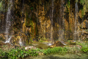 Beauty in nature, amazing waterfall in forest. Waterfall and pond. Panoramic beautiful deep forest waterfall. Beautiful view to waterfalls with green forest. The tranquil waters of waterfall cascade.