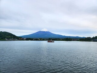Mount Fuji and Lake Kawaguchi with a boat in the middle in Fujikawaguchiko, Japan