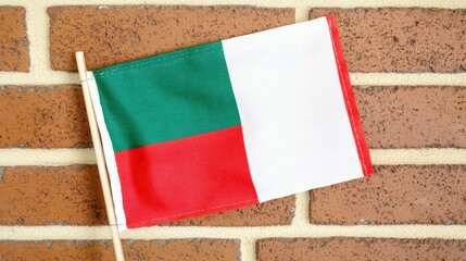 Close-up of a Small Malagasy Flag on a Brick Wall