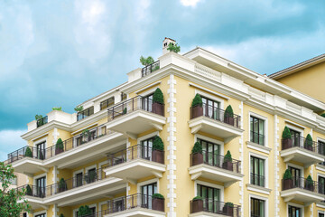 Fototapeta premium Residential building exterior with decorated balconies