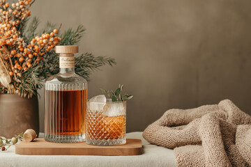 Close-up of a premium Irish whiskey bottle with a glass of whiskey on the rocks, set on a wooden surface with warm lighting and a dark background.