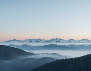 Serene Dawn Over Misty Mountain Ranges: Panoramic View of Peaks and Fog