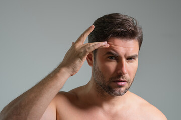 Obraz premium Caucasian beauty man use moisturizing face balm for healthy skin, male skincare concept. Male beauty and skin care portrait. Healthy clean face after shaving, facial treatment, skincare concept.