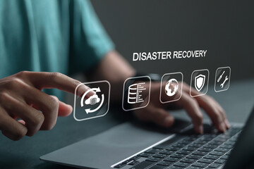 Disaster recovery concept, IT system protection. Person using laptop with disaster recovery icon on...