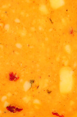 Cheddar cheese slice with mixed peppers and spices flavour background texture