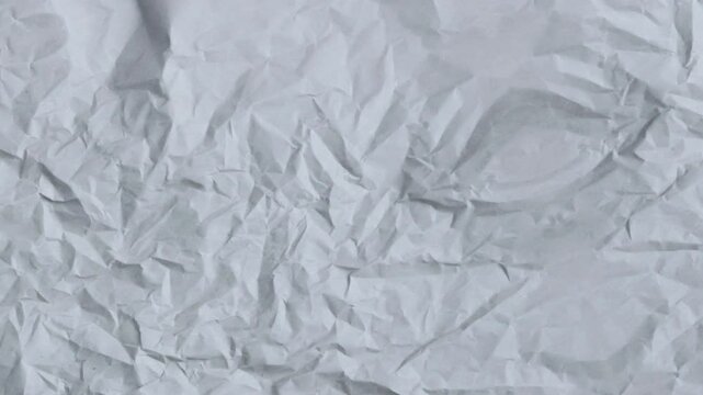 Seamless loop animation features a white grunge, wrinkled paper texture as the background. Stop-motion backdrop overlay footage