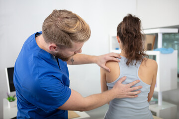 Fototapeta premium physiotherapist working with patient in clinic
