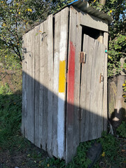 An old wooden toilet outside