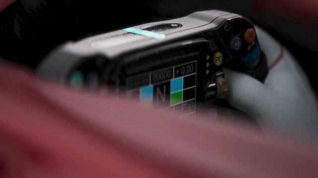CLOSE-UP High-tech racing cockpit showing a steering wheel and digital display