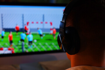 Young man playing video game at table indoors, closeup. Space for text