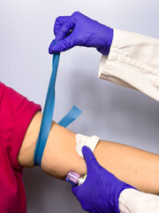 A person is getting a blood test and a nurse is holding a syringe