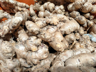 Fresh ginger root at the market. Agricultural background texture