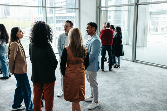 Group of professionals networking during a conference at a modern office event