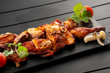 Mexican fried chicken placed on a black slate