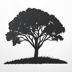 Fototapeta premium Silhouette of a large tree on a small hill.