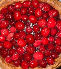 Top view of festive cranberry pie showing lush cranberries