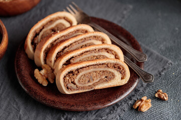 Bejgli, home-baked walnut roll, traditional Hungarian, Eastern European Christmas and Easter sweet bread in slices stuffed with ground walnuts filling