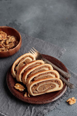 Bejgli, home-baked walnut roll, traditional Hungarian, Eastern European Christmas and Easter sweet bread in slices stuffed with ground walnuts filling. Copy space