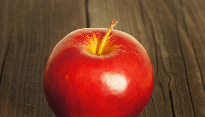 Ripe red apple on a wooden table
