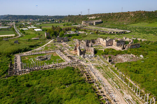 Aerial view of ancient ruins with columns in a scenic landscape, Perge, Antalya, Turkey.