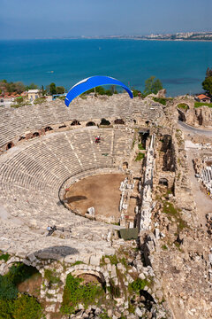 Aerial view of ancient ruins and a historic amphitheater by the sea, Side, Turkey.
