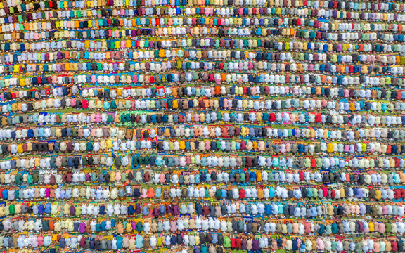 Aerial view of masses of people kneeling down for prayer during eid al-fitr celebration, Kishoreganj, Bangladesh.