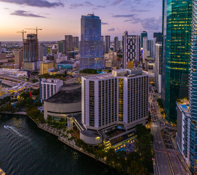 Aerial view of vibrant Brickell skyline with skyscrapers and Miami River at sunset, Miami, USA.