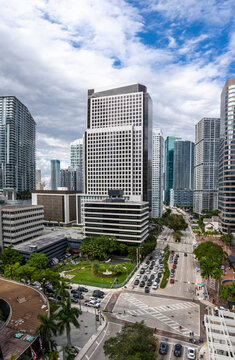 Aerial view of vibrant Brickell skyline with modern skyscrapers and busy streets under a cloudy sky, Miami, USA.