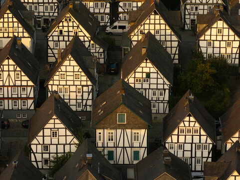 Aerial view of historic half-timbered houses in a picturesque village at sunrise, Freudenberg, Germany.