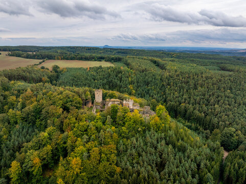 Aerial view of the abandoned medieval Burg Helfenburk castle surrounded by autumn foliage and dense forest, Ustek, Czech Republic.